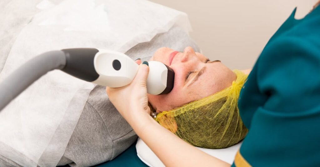 A woman receiving professional facial treatment at a clinic, highlighting beauty and technology.